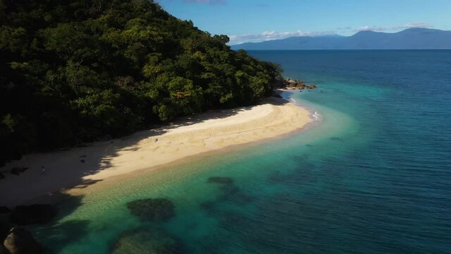 Rotating drone shot of Fitzroy Island Nudey beach in Queensland, Australia