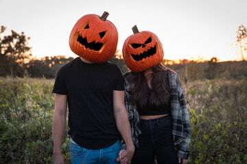 "Clermont, FL / USA - 10-31-2020: Cute couple as pumpkin heads during Halloween."