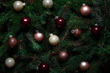 Christmas decorative balls on tree branches. Christmas background. Nature New Year concept. Pattern, texture. Flat lay, top view. Creative