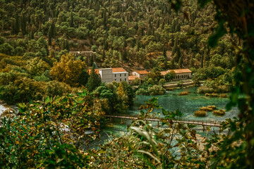 Fototapeta na wymiar View of the Krka park in Croatia. Waterfall and trees in the mountains
