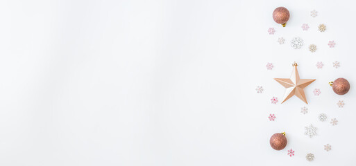 Flat lay border with christmas balls, stars and snowflakes on a white background