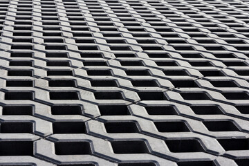 Decorative paving tile. Part of urban street covered with gray concrete cubes. The footpath in the street