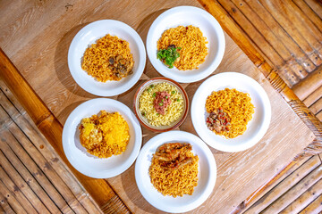 Indonesian instant noodles are served in white plates and arranged in such a way on the table.