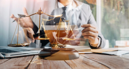 Business and lawyers discussing contract papers with brass scale on desk in office. Law, legal services, advice, justice and law concept picture with film grain effect