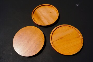Wooden cup base handmade on black background