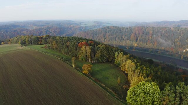 aerial flight over colorful trees and river Elbe in Saxon Switzerland, Germany