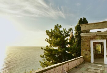 Fototapeta premium Top view of the sea coast and the horizon during sunset from the ruins of an abandoned building