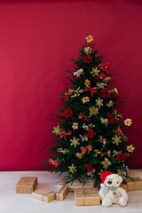 red decor garland Christmas tree with gifts for the new year interior