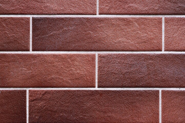 Fototapeta premium Texture of brown wall of decorative tiles or bricks.