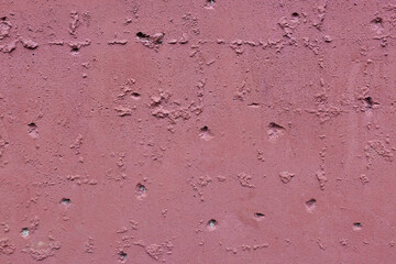 Close up texture of pink rough concrete wall or plaster.