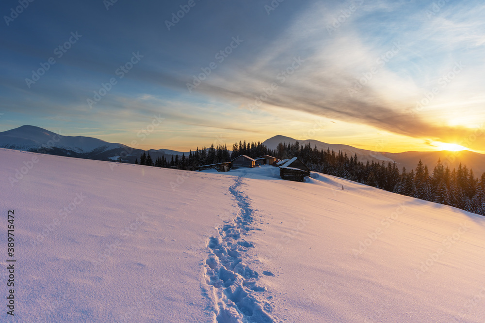 Wall mural severe winter on a mountain range in the ukrainian carpathian mountains with cozy houses and a magni