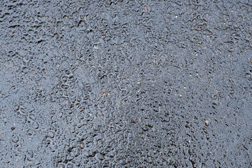 Dark texture of asphalt, wet road surface.