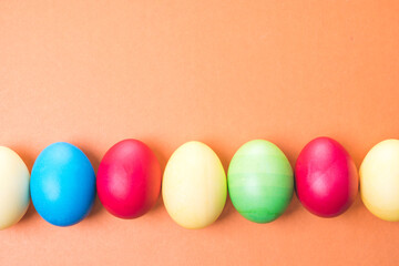multicolored Easter eggs on a brown background, close-up
