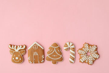Different Christmas gingerbread cookies on pink background, flat lay. Space for text