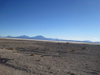 Sunset over the stunning salt flats, desert and mountain landscapes around Salar de Uyuni in Bolivia, South America