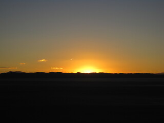 Sunset over the stunning salt flats, desert and mountain landscapes around Salar de Uyuni in Bolivia, South America