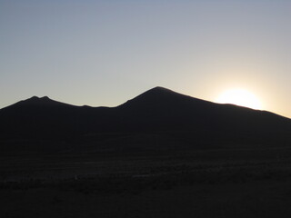 Sunset over the stunning salt flats, desert and mountain landscapes around Salar de Uyuni in Bolivia, South America