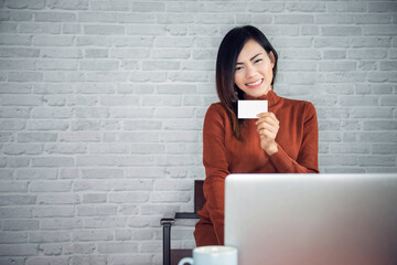 Asian beautiful woman holding a blank billboard advertising card Happy