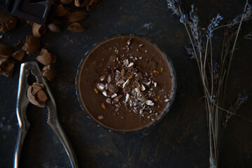 High angle shot of a delicious chocolate mousse with nuts on the table