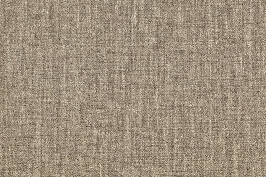 Texture of coarse natural cotton fabric. Rough sacking of brown color.