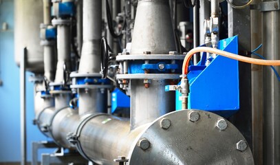 Large industrial water treatment and boiler room. Piping, flanges, butterlfy valves, rusty and...