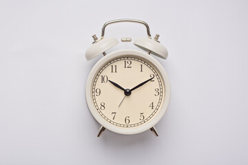Alarm clock on the gray background