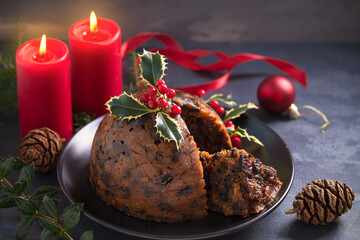 Richly spiced Christmas pudding cake with custard and Christmas decorations