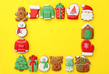 Frame made with different Christmas gingerbread cookies on yellow background, flat lay. Space for text