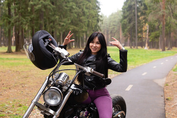 Fototapeta na wymiar Happy girl on a motorcycle