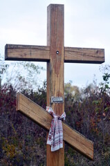 Big wooden christian cross standing in park