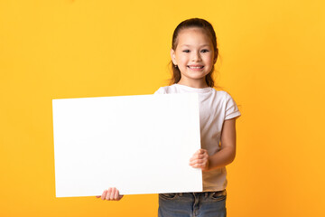 Asian girl holding blank white advertising board