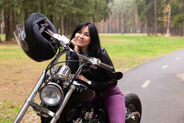 Fototapeta na wymiar beautiful brunette on a motorcycle on the track