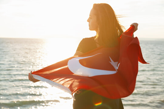 Young Woman With Turkish Flag On Sky And Sea Background With Copy Space.