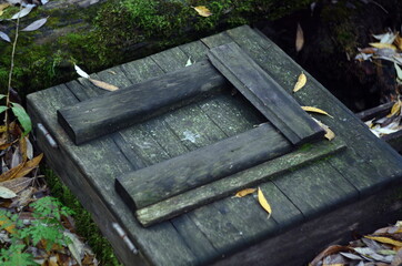 Fototapeta premium Wooden cover of the well in the grove
