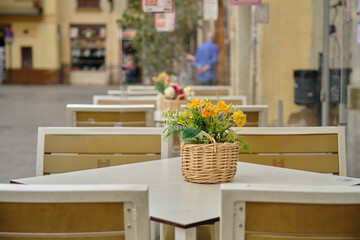empty cafe tables on the street