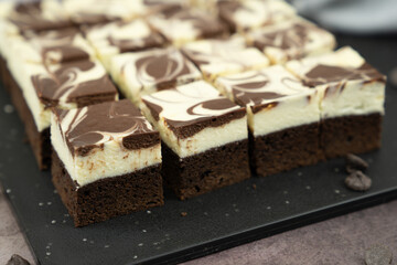 Cutting of homemade cheesecake swirl brownie or fudge