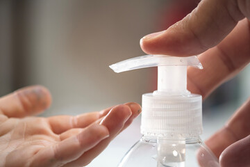 Daddy help his little child daughter girl to sanitize hand with alcohol gel sanitizer disinfectant,Kids care,covid19 pandemic disease