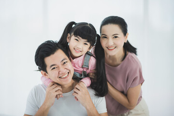 Happy asian family father mother with daughter looking camera with smile face.