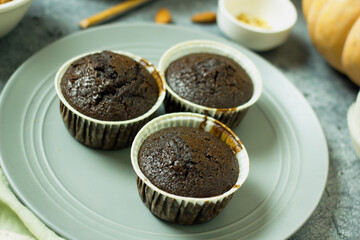 Homemade gluten-free muffins with chocolate close-up. Gluten-free flour cupcakes with chocolate on a green plate with a napkin on a dark table. Low Carb Sugar Free Cupcakes