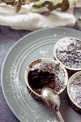 Homemade gluten-free muffins with chocolate close-up. Gluten-free flour cupcakes with chocolate on a green plate with a napkin on a dark table. Low Carb Sugar Free Cupcakes