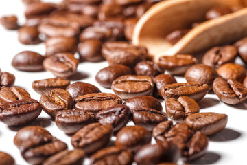 Freshly roasted coffee beans background.Dark roasted coffee beans with scoop on wooden background.