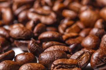 Freshly roasted coffee beans background.Dark roasted coffee beans with scoop on wooden background.