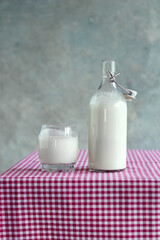 Kefir in a bottle and glass on a table