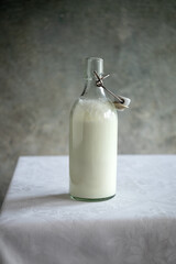 A bottle of kefir on a white table