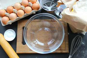 A bowl of flour and egg on the kitchen table.Preparation of home-made dough. Baking ingredients