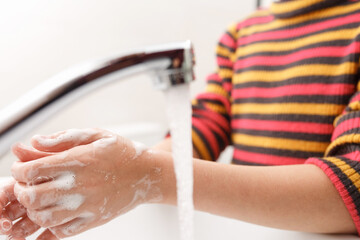 Washing hands with soap.