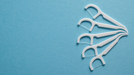 Dental hygiene concept. Set of dental floss, toothpick. Plastic white dental toothpick with floss. Dental floss