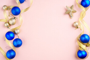 Christmas tree beautiful toy balls, gold ribbon, place for text. New Year's content. Flat lay.