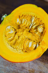 Half a ripe orange pumpkin on a cutting board. Ingredients for cooking.