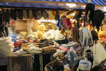 a lot of winter warm clothes in market for sale, shopping on holidays, black friday and xmas